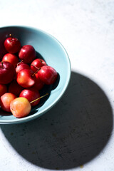Crabapples in a blue bowl on white background