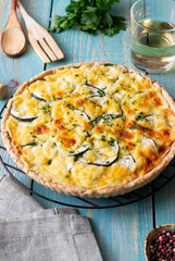 Pie with zucchini, cheese and herbs. Quiche. Vegetarian food. Healthy eating.