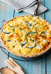 Pie with zucchini, cheese and herbs. Quiche. Vegetarian food. Healthy eating.
