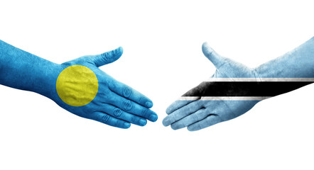 Handshake between Botswana and Palau flags painted on hands, isolated transparent image.