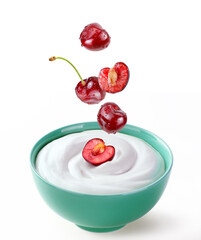 cherries pieces drop in bowl of cream sour