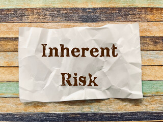 inherent risk word on crumpled paper note