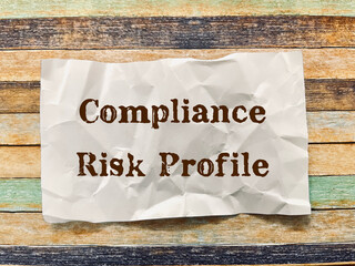 compliance risk profile word on crumpled paper note