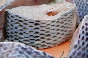 Jalebi fish cut piece kept in a plate for cooking at the restaurant.