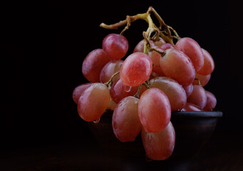 Bunch of ripe red grapes. Beautiful grapes on a dark background.