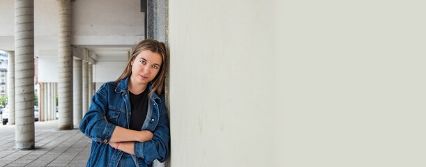 urban young girl posing on city wall with copy space