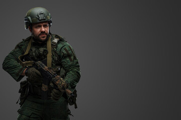 Portrait of military russian man with rifle dressed in modern camouflage uniform.