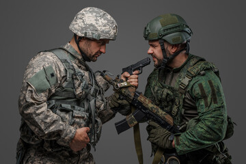 Studio shot of disagreements soldiers dressed in camouflage uniforms.