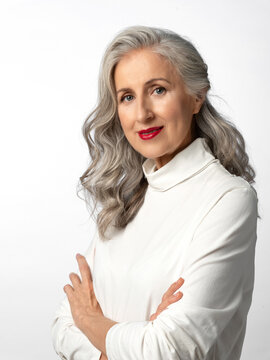 Beautiful stylish and elegant old woman. Portrait of an old lady with gray hair on a white background.