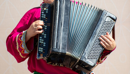 A man plays the button accordion.