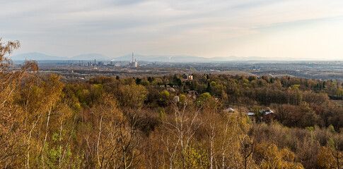 Obraz premium Nova hut dactory and Moravskoslezske Beskydy mountains on the background from Halda Ema hill in Ostrava city in Czech republic
