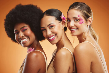 Beauty, skincare and diversity with a model woman group in studio on an orange background for health or inclusion. Wellness, makeup and face with a portrait of female friends posing for empowerment