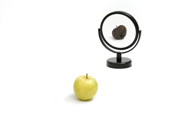Surrealistic picture of an apple reflecting in the mirror
