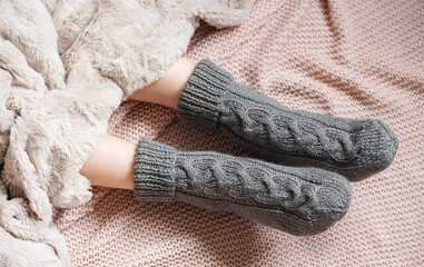 Legs of a young girl in cozy knitted socks
