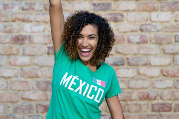 Naklejka na ściany i meble Cheering mexican female football fan