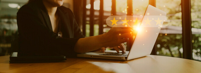 close up Man hand using smartphone with popup five star icon for feedback review satisfaction...