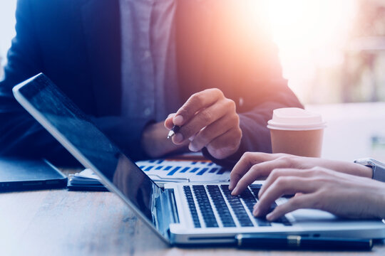 businesswoman hand working with laptop computer, tablet and smart phone in modern office with virtual icon diagram at modernoffice in morning light