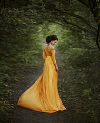 fantasy woman walking in summer nature green trees forest. Girl renaissance style princess Long...