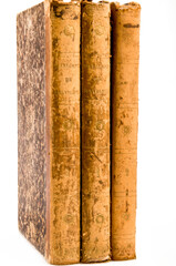 three old books stacked, spine view