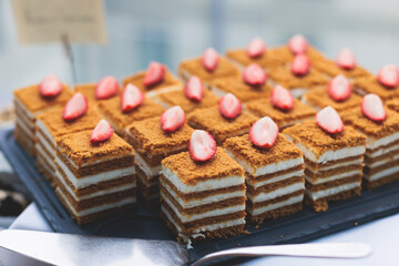 Catering table, beautifully decorated banquet with variety of with different food snacks appetizers on corporate birthday party event or wedding celebration, canape, salad, delicatessen setting
