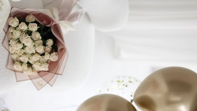 Bouquet of white flowers in gift packaging. Birthday present