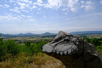 monolithic rock statues with hills in background