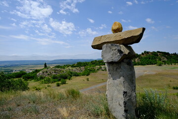 monolithic rock statues with hills in background