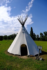 teepee tent in green field