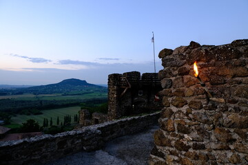 castle on the hill with torch at dusk