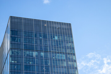 Modern glass facade. Bottom view of a building in the business district. Glass facade of an office building background