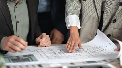 Architect business meeting colleagues discuss development construction engineering project blueprint
