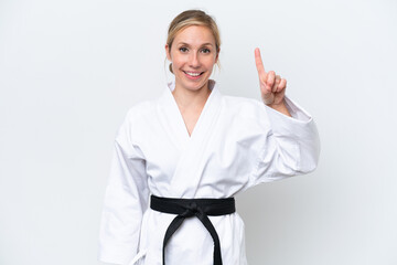 Young caucasian woman doing karate isolated on white background showing and lifting a finger in sign of the best
