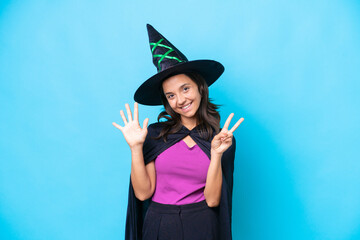 Young hispanic woman dressed as witch over isolated background counting seven with fingers