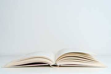 Open book on the table. A book with a white page on a light empty background. Education, school, study, reading concept