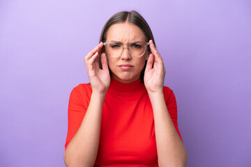 Young caucasian woman isolated on purple background With glasses and frustrated expression