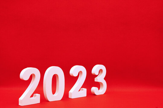 Happy New year 2023 , 2023 number wood object on red background and copy space - red color new year celebrate and business resource concept -  marketing resource design template 