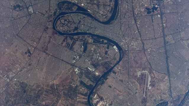 Aerial high altitude satellite view of downtown Baghdad also showing the Tigris river it is the capital of Iraq and the second largest city in the Arab world after Cairo 4k resolution animation