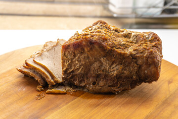 roasted pork tenderloin, juicy and succulent oven-baked piece of meat rubbed with mustard and spices on a wooden background, close-up,  food concept