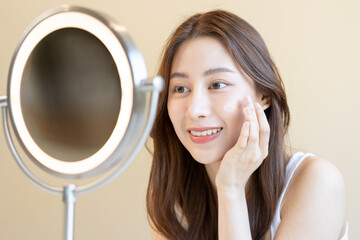 Fresh healthy skin, beautiful smile of asian young woman, girl looking at mirror, applying...