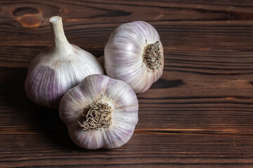 Garlic bulb on wooden background close up