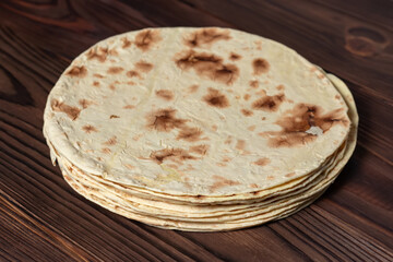 Taco flatbread lavash isolated on wooden background