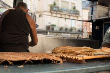 Unrecognizable person cooking crepes in a food truck