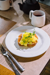 Egg benedict with hollandaise sauce and smoked salmon on toast
