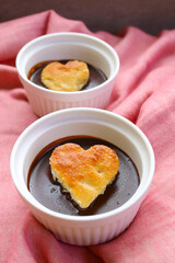 A Pair of Chocolate Mousse Decorated with Heart Shaped Chiffon Cakes