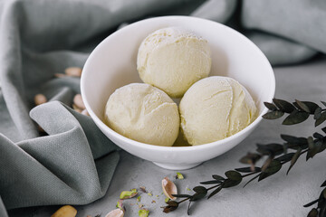 Pistachio ice cream scoops on a bowl