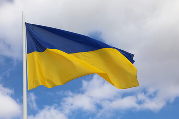BLUE Yellow Flag of UKRAINE waving in the blue sky with clouds