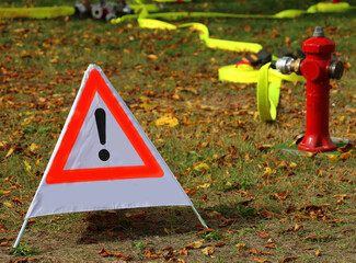 triangle with large exclamation mark and a fire hydrant