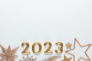 Fototapeta New year 2023 number, golden digits and santa hat over blue background. obraz