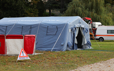camp equipped with a tent and warning signs and the text in Italian which means CIVIL PROTECTION
