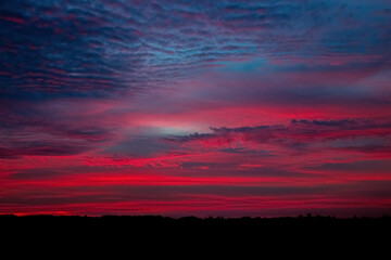 Beautiful sky background with clouds after sunset. Red sky